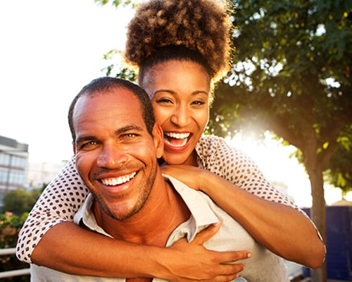 couple riding piggyback smiling